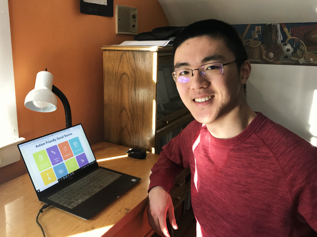 A photo of Jeff sitting at his desk with his laptop open on a colorful "Autism Friendly Social Stories" website.